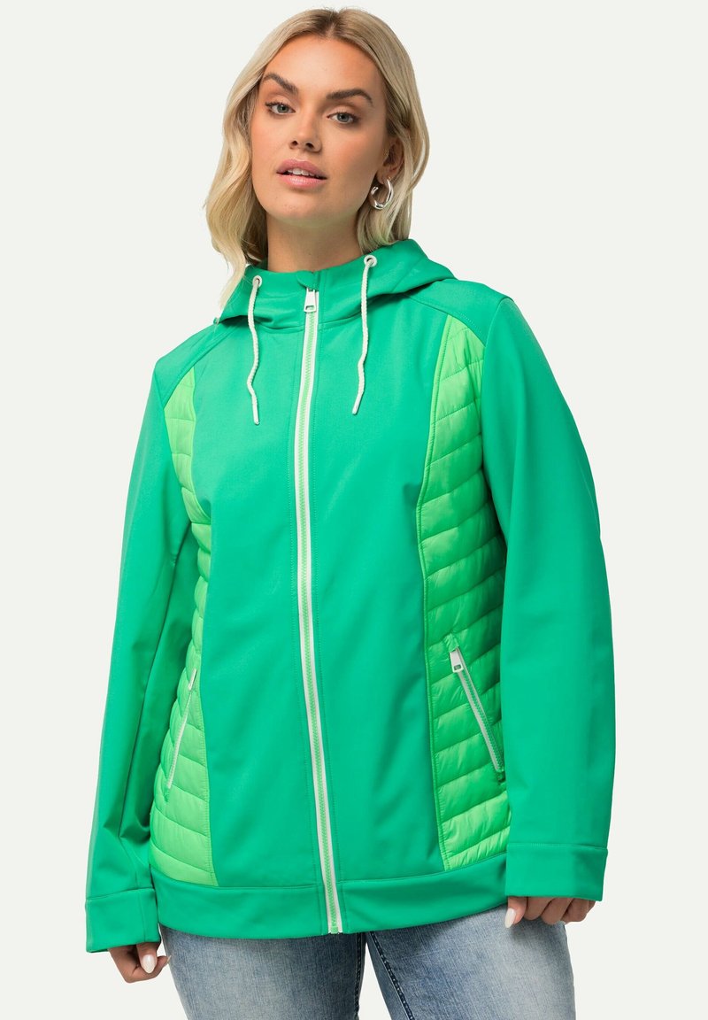 Vihreä hupparikotelo, jossa on vetoketju edessä ja joka sisältää päällystettyjä paneeleita sivuilla. Kevyt kangas, kaksi sivutaskua ja kiristysnauha hupussa.