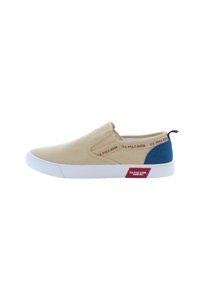 Canvas slip-on shoe in beige with navy blue accent. White rubber sole. Features red logo text along the side and small red label on the heel.