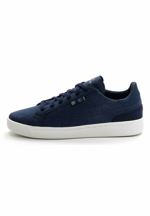 Navy blue sneakers featuring a textured fabric upper, white rubber sole, and minimalistic design with laces and subtle detailing on the side.