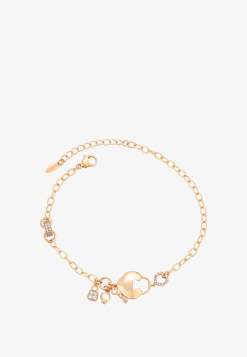 Arany színű karkötő lánc mintával, szív alakú záródással, kis charmokkal és egy szakaszban átlátszó kő díszítéssel.