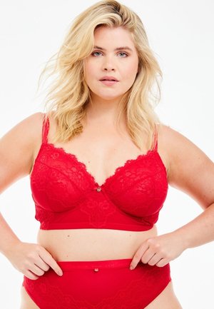 Red lace bra with a scalloped design, semi-sheer texture, and decorative button detail at the center. Matching high-waisted lace underwear.