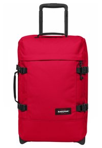 Red wheeled duffel bag with a rectangular shape, made of sturdy fabric, featuring adjustable straps and a retractable handle.