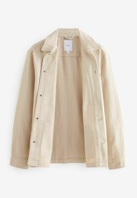 Giacca beige chiaro realizzata in tessuto pesante, con colletto classico, chiusura a bottone e due tasche laterali. L'interno è liscio e non foderato.