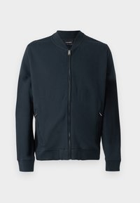 Veste bomber bleu marine en tissu lisse, avec une fermeture éclair à l'avant, des poches latérales zippées et des poignets et un ourlet en côtes.