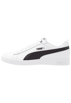 White sneaker with black synthetic side stripe and Puma logo, featuring a smooth texture, rounded toe, and lace-up closure.