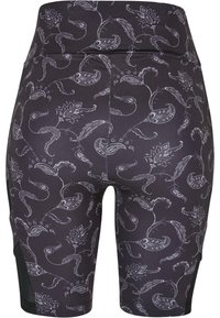 Pantaloni corti neri realizzati in tessuto elasticizzato con un motivo floreale paisley bianco. Presentano un'alta vita e pannelli neri accentuati sui lati.