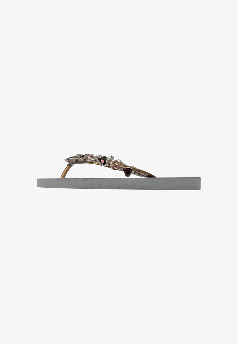 Decorative flip-flop featuring a grey foam sole, metallic strap with multi-colored gemstones in heart shapes, and textured detailing.