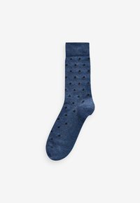 Navy blue sock with a textured fabric, featuring regular black polka dots throughout and a ribbed cuff at the top.