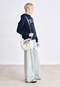 Tommy Jeans PILLOW MINI HOBO - Handbag - offwhite