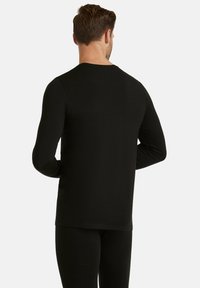 Long-sleeve black moisture-wicking thermal shirt with a round neck and fitted design, made from a soft, textured material.