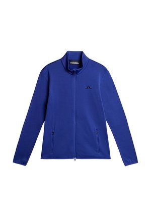 Blaues Zip-Up-Jackett aus glattem Stoff, mit hohem Kragen und zwei seitlichen Reißverschlusstaschen, mit einem kleinen schwarzen Logo auf der Brust.