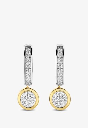 Silver and gold drop earrings with a row of small diamonds on the hoop and a large round diamond encased in gold at the bottom.