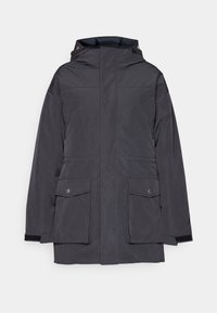 Mörkgrå isolerad parkas med huva, som har två framfickor, tryckknappar och ribbade ärmslut. Slät, matt tygtextur.