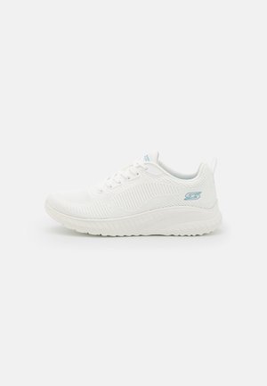 White athletic shoe with breathable mesh upper, textured design, light blue accents, and a cushioned sole. Features laces and a pull tab.
