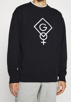 Czarny sweter z białym geometrycznym logo przedstawiającym literę "G" oraz symbol kobiecy. Materiał bawełniany; ściągacze przy mankietach i u dołu.