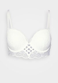 Soutien-gorge en dentelle blanche avec des coques rembourrées, des bords festonnés, des motifs géométriques et des bretelles en satin réglables. Finition en dentelle le long de la bande.
