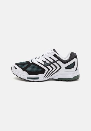 White and black athletic sneaker with dark green mesh, Nike swoosh, and cushioned sole viewed from the outer side against plain background.