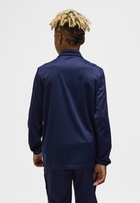 Navy long-sleeve top with a high collar, made from smooth fabric; features long sleeves and a relaxed fit.