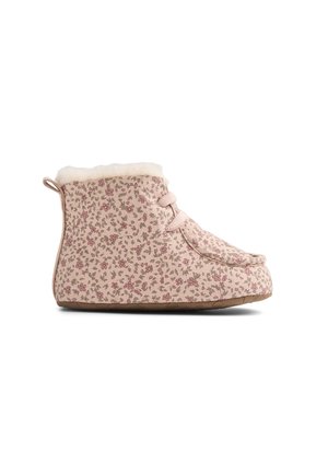 Light pink ankle-height slipper with a small floral print, faux fur lining, rubber sole, and lace-up front, viewed from the side.