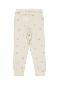 Krämfärgade babyleggings med små ljusbruna hjärtmönster, elastisk midja och avslutade anklar.