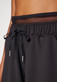Puma PAMELA REIF SHORTS - Sporta šorti - black