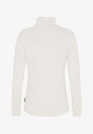 Camisa de manga larga con cuello en beige claro, que presenta una textura suave, un dobladillo curvado y detalles de costura sencillos. No hay marcas visibles destacadas.