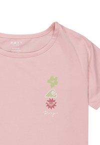 Pink cotton t-shirt featuring floral, wave, and heart graphics in green and red. Rounded neckline and short sleeves. Roxy branding included.
