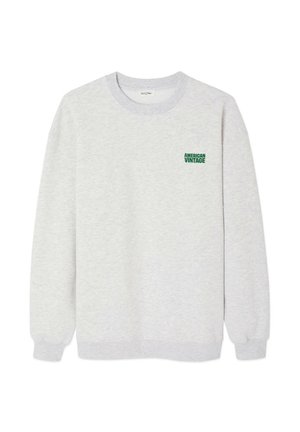 Svetložltý sveter vyrobený z jemnej látky, s rebrovaným výstrihom a manžetami. Na hrudi má zelené logo "AMERICAN VINTAGE".