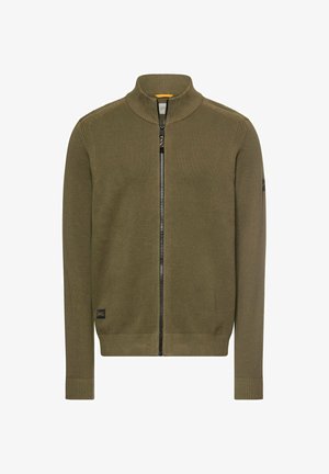 Olive green zip-up sweater with a high collar, textured knit pattern, ribbed cuffs and hem, and a subtle logo patch on the sleeve.