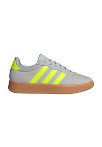 Gray suede sneaker with three bright yellow stripes, light gray laces, and a gum rubber sole. Smooth texture with a low-profile design.
