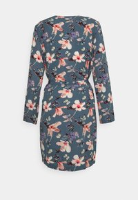 Blommig klänning med långa ärmar, knytmidja och en blå bakgrund med rosa och lila blommor och fjärilar. Tillverkad av bomull, mjuk textur.