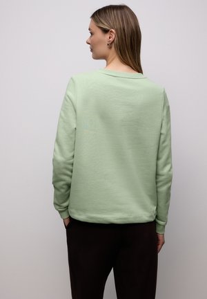 Lichtgroene sweatshirt met lange mouwen, een ronde hals en een losse pasvorm. Zachte textuur, geribbelde manchetten en tailleband.
