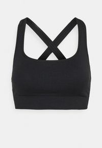 Sutiã desportivo preto com uma textura canelada, alças largas e um design cruzado nas costas. O material parece elástico e ajustado.