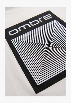 Lignes carrées géométriques en noir et blanc formant un motif concentrique avec le mot "ombre" au-dessus sur un fond de tissu blanc.
