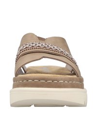 Beige sandal with cross strap design, textured suede upper, subtle braided detail, and cushioned sole with white stitching.
