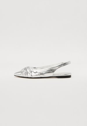 Hõbedane metallikust slingback lame king, terava toe ja esiosas tekstuurse sõlmega detailiga, ning kitsas musta tallaga. Sile viimistlus, minimalistlik disain.