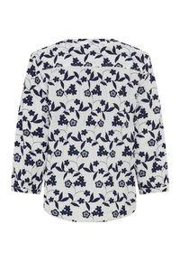 Langærmet bluse i let hvidt stof med marineblå blomsterprint. Har en rund kant og en afslappet pasform.