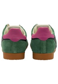 Green suede sneakers with a pink leather heel accent and black side panel. Features a brown rubber sole and soft inner lining.