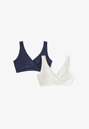 Zwei Bralettes: eines aus einfarbigem marineblauem Stoff mit einem Wickeldesign und eines in Creme mit Blumenmuster, beide mit breiten Trägern.