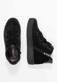 Black suede high-top sneakers with thick rubber soles, side zipper, and velcro straps, shown from top and side views on white background.
