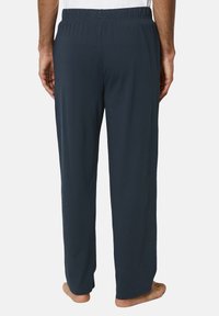 Navy cotton lounge pants with an elastic waistband, straight leg design, and a smooth texture, displaying a relaxed fit with no patterns.
