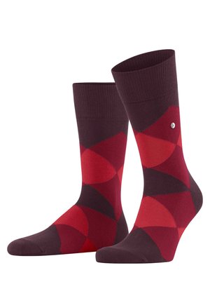 Calcetines de algodón rojos y marrones con un patrón geométrico de círculos superpuestos, un puño acanalado y un pequeño detalle de logo en el lateral.