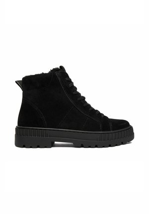 Black suede ankle boot with thick rubber lug sole, lace-up front, padded collar, and pull tab at the heel, shown in a side profile.