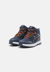 Baskets montantes bleu marine avec lacets orange, dessus synthétique texturé, col rembourré et semelle en caoutchouc blanc avec de profonds motifs de semelle.