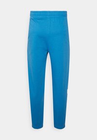 Blauwe katoenen sweatpants met een elastische tailleband, taps toelopende pijpen en omgeslagen zomen. Gladde textuur, minimalistisch ontwerp zonder zakken of versieringen.