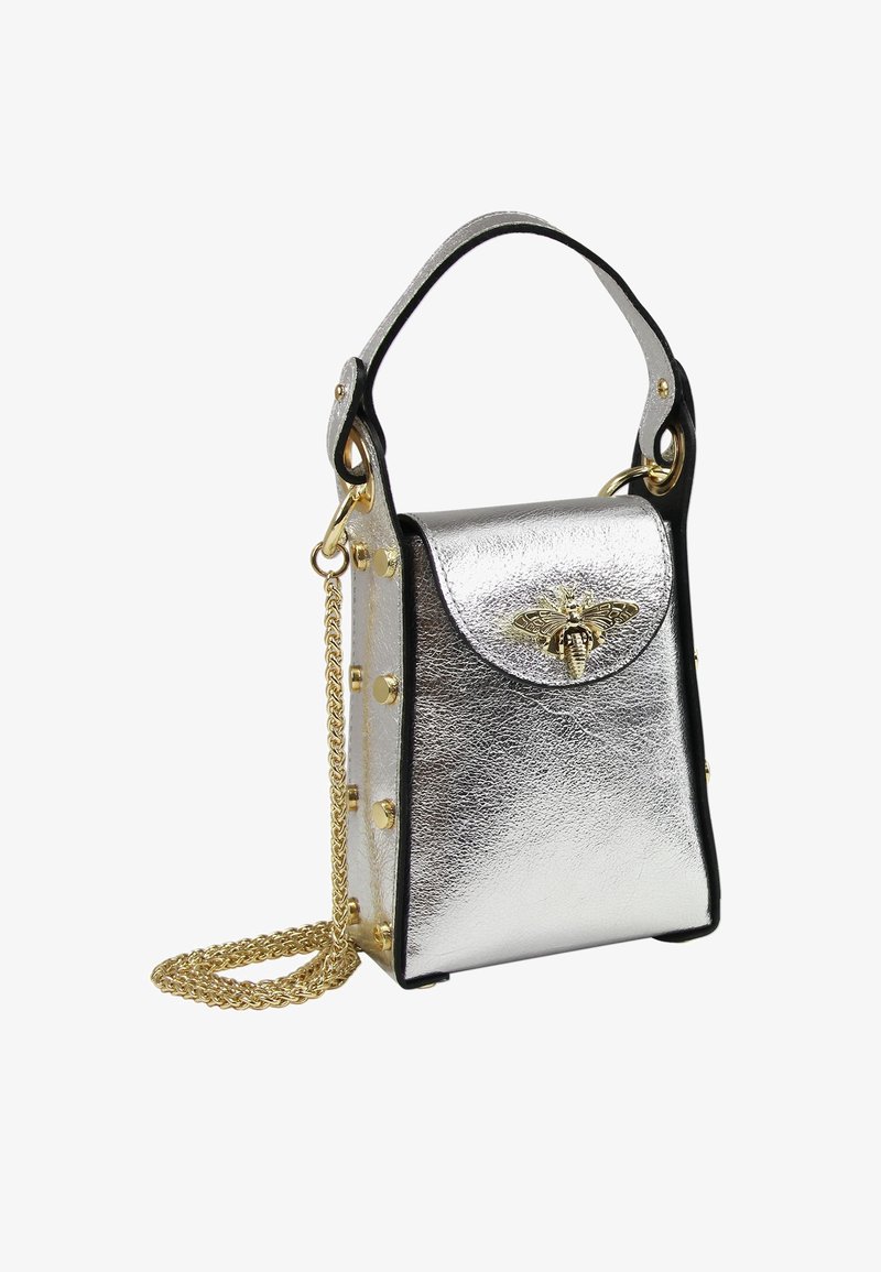 Silver metallic handbag with black accents, featuring a top handle, chain strap, gold studs, and a decorative bee emblem on the flap.