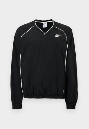 Fekete Nike pulóver felső V-nyakkivágással, hosszú ujjal, rugalmas szegéllyel, fehér csíkozással és logóval a mellkason. Könnyű anyag.