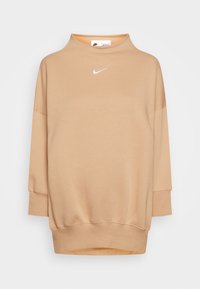 Beige Nike-tröja med hög krage, långa ärmar och en lös passform. Har en liten vit logotyp på bröstet och ribbade mudd.