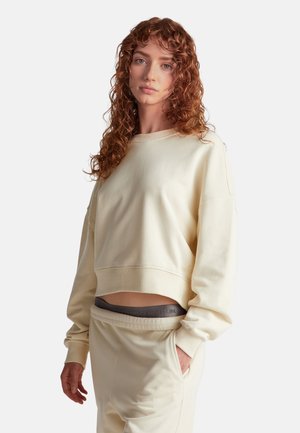Lichtgele cropped sweatshirt van zachte stof, met een ronde halslijn en lange mouwen. Gecombineerd met bijpassende broeken met een logo-band.
