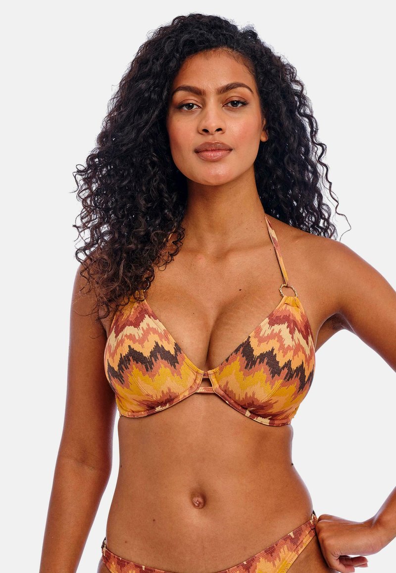 Geprinte bikini-top met een levendig zigzagpatroon in oranje, geel en bruine tinten. Gemaakt van soepel materiaal met verstelbare bandjes.